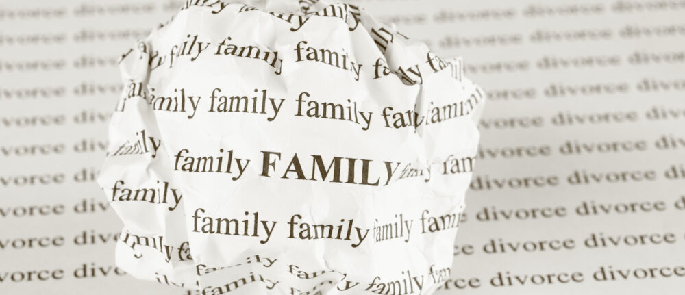 Crumpled paper ball with words "Family" on background with words "divorce".