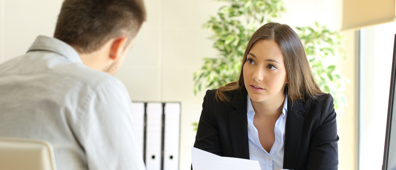 Man and businesswoman talking in a job termination in an office