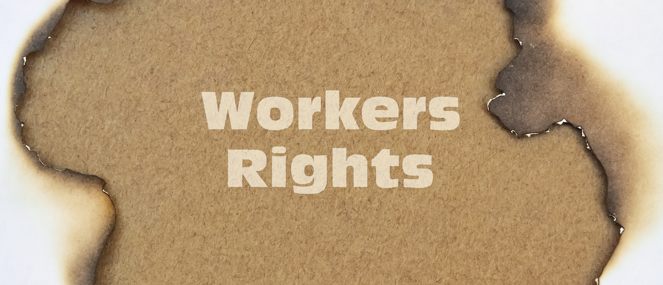 Text Workers Rights written on a burnt paper